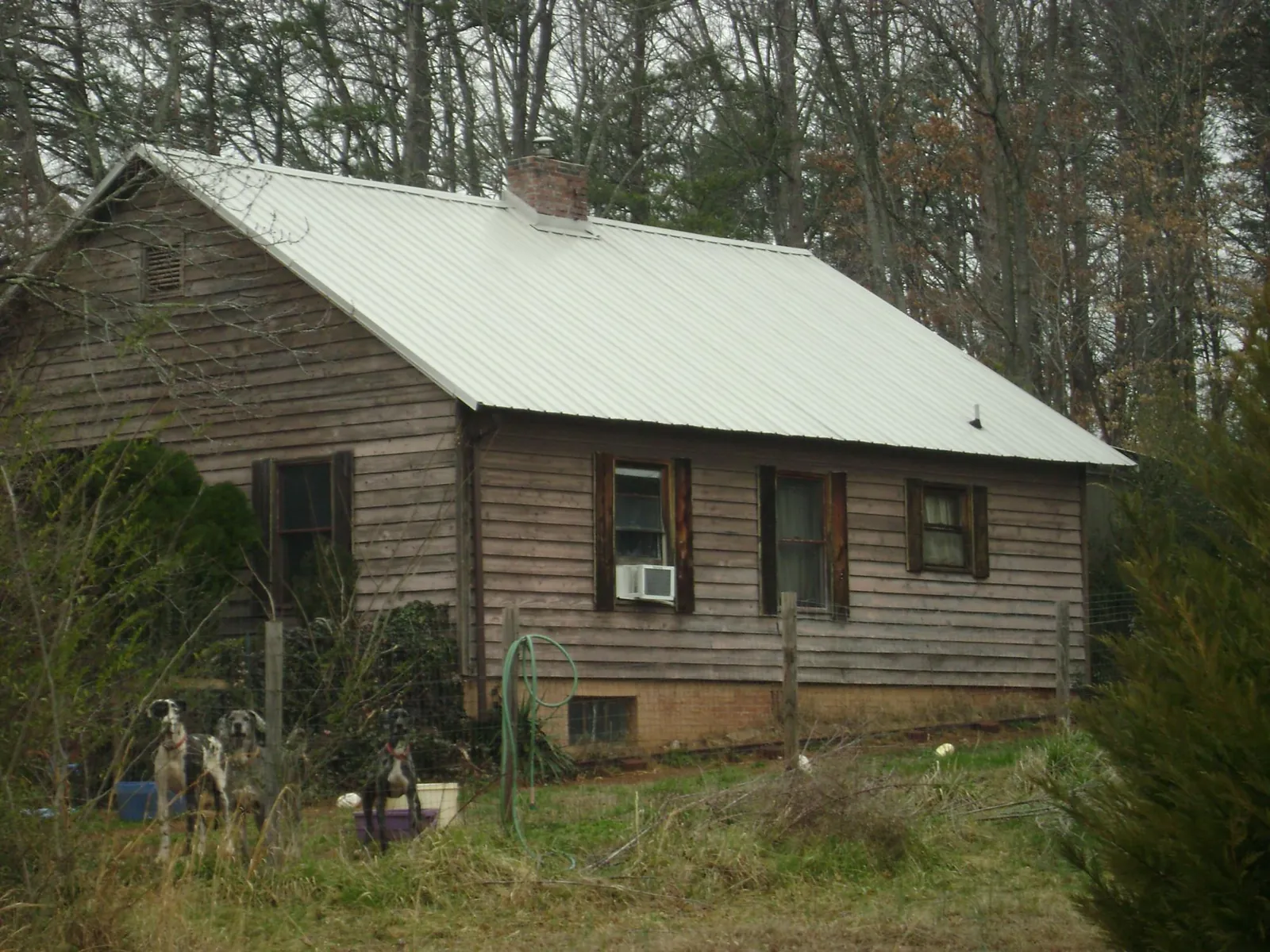 White metal roof on an old wood sided farmhouse, from a Metal Roof Installation job in New Gretna